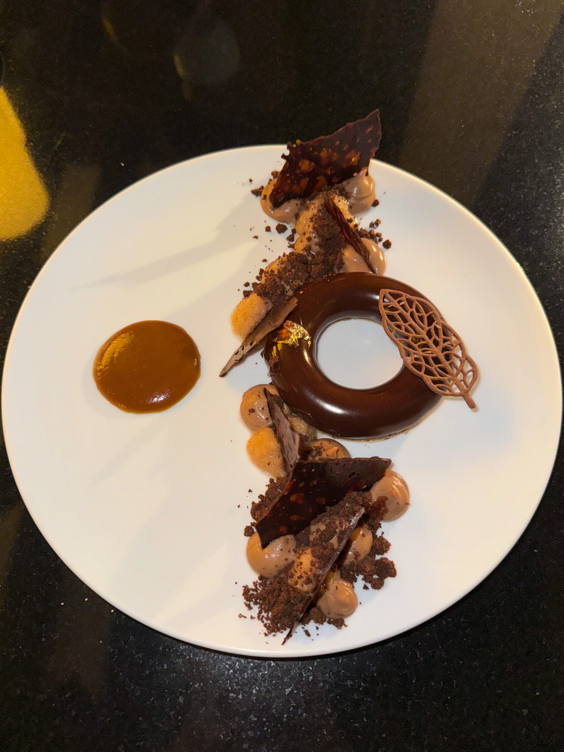 MILK CHOCOLATE AND QUINCE CRÉMEUX (dessert dish of chocolate donut and sauce) from Q at the Fairmont Empress