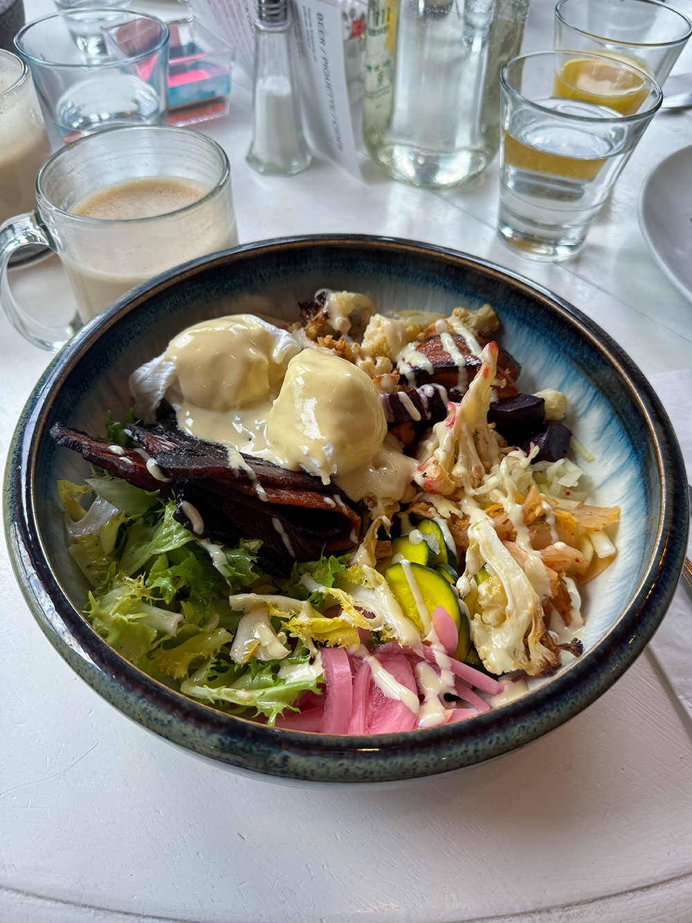 Grain Bowl (2 poached eggs, millet, quinoa and brown rice, pickles, roasted cauliflower, tahini sauce *vegan with tempeh, bacon) at the Nourish Kitchen and Cafe, Victoria, BC